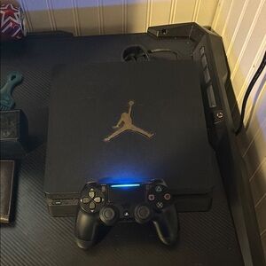 Black PlayStation 4 Console with Slim Design and Illuminated Controller